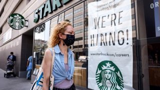 A ‘We’re Hiring!’ sign is posted at a Starbucks on August 06, 2021 in Los Angeles, California.