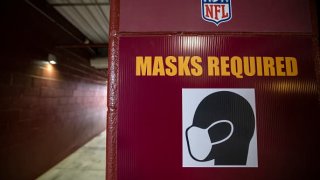 A detailed view of a “Masks Required” sign in the stadium concourse before the game between the Washington Football Team and the Dallas Cowboys at FedExField on October 25, 2020 in Landover, Maryland.