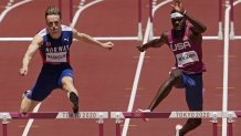 Karsten Warholm, of Norway, left, clears the final hurdle before winning the gold medal ahead of Rai Benjamin, of United States in the final of the Men's 400-Meter Hurdles at the 2020 Olympics, Tuesday, Aug. 3, 2021, in Tokyo, Japan.