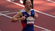 Karsten Warholm, of Norway celebrates, ripping his shirt, as he wins the gold medal and sets a new record in the final of the men's 400-meter hurdles at the 2020 Olympics, Tuesday, Aug. 3, 2021, in Tokyo, Japan.