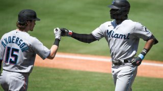 SAN DIEGO, CA – AUGUST 11: Lewis Brinson #25 of the Miami Marlins, right, is congratulated by Brian Anderson #15 after hitting a solo home run during the third inning of a baseball game against the San Diego Padres at Petco Park on August 11, 2021 in San Diego, California. (Photo by Denis Poroy/Getty Images)