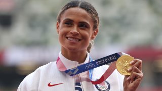 Syndey McLauglin posing with gold medal