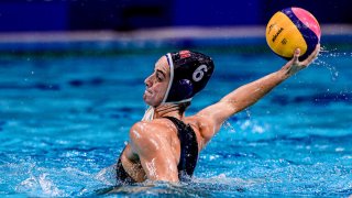 Margaret Steffens winds up to throw the water polo ball.