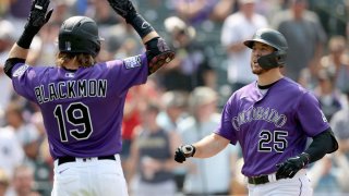 DENVER, COLORADO – AUGUST 08: C.J. Cron #25 of the Colorado Rockies is congratulated by Charlie Blackmon #19 after hitting a grand slam home run against the Miami Marlins in the fourth inning at Coors Field on August 08, 2021 in Denver, Colorado. (Photo by Matthew Stockman/Getty Images)