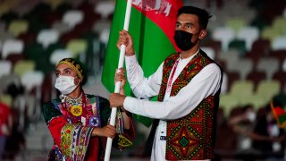 Jul 23, 2021; Tokyo, Japan; Afghanistan athletes march into the stadium during the opening ceremony for the Tokyo 2020 Olympic Summer Games at Olympic Stadium.