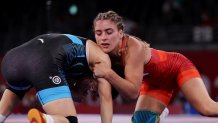 Helen Maroulis in red gets on top of China's Ningning Rong in a 1/8 final wrestling match at the Olympics