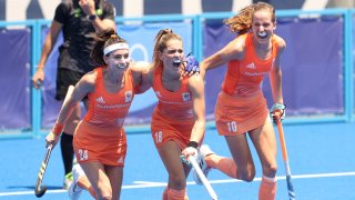 An ecstatic trio of Netherlands player celebrate one of five goals against GB