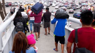 asylum-seeking migrants depart on the Mexican side