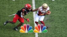 LOUISVILLE, KENTUCKY - OCTOBER 24: Lovie Jenkins #1 of the Louisville Cardinals tackles Jordan Travis #13 of the Florida State Seminoles at Cardinal Stadium on October 24, 2020 in Louisville, Kentucky. (Photo by Andy Lyons/Getty Images)