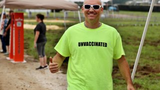 A man wears an ‘UNVACCINATED’ t-shirt ahead of U.S. President Donald Trump’s “Save America” rally at York Family Farms on August 21, 2021 in Cullman, Alabama.