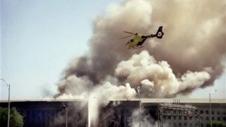 FILE – In this Sept. 11, 2001 file photo, a helicopter flies over the Pentagon in Washington as smoke billows over the building. Partial remains of several 9/11 victims were incinerated by a military contractor and sent to a landfill, a government report said Tuesday, Feb. 28, 2012, in the latest of a series of revelations about the Pentagon’s main mortuary for the war dead. The terrorist-hijacked airliner that slammed into the west side of the Pentagon killed 184 people. (AP Photo/Heesoon Yim,