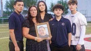 Karyn Arellano holds a photo of her husband