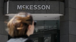 Pedestrian passes a McKesson sign