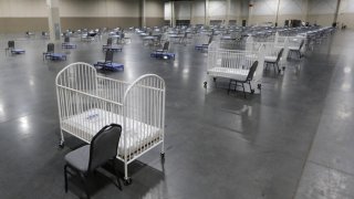 FILE - In this Monday, April 6, 2020 file photo, cots and cribs are arranged at the Mountain America Expo Center in Sandy, Utah, as an alternate care site or for hospital overflow amid the COVID-19 pandemic. According to a government report released on Wednesday, May 5, 2021, the U.S. birth rate fell 4% in 2020, the largest single-year decrease in nearly 50 years. The rate dropped for moms of every major race and ethnicity, and in nearly every age group, falling to the lowest point since federal health officials started tracking it more than a century ago.