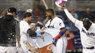 MIAMI, FL – SEPTEMBER 19: Lewin Díaz #68 of the Miami Marlins celebrates with teammates at home plate after hitting a home run in the tenth inning to win the game against the Pittsburgh Pirates at loanDepot park on September 19, 2021 in Miami, Florida. (Photo by Bryan Cereijo/Getty Images)