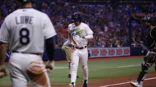 Miami Marlins' Lewis Brinson (9) strikes out with runners on base