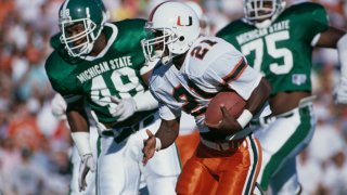 Alex Johnson #21, Running Back for the University of Miami Hurricanes runs the ball during the NCAA Big 10 college football game against the Michigan State Spartans on 30th September 1989 at the Spartan Stadium in East Lansing, Michigan, United States. The Miami Hurricanes won the game 26 – 20. (Photo by Brian Masck/Allsport/Getty Images)