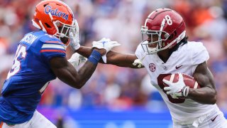 GAINESVILLE, FLORIDA – SEPTEMBER 18: John Metchie III #8 of the Alabama Crimson Tide runs for yardage against Tre’Vez Johnson #16 of the Florida Gators during the first quarter of a game at Ben Hill Griffin Stadium on September 18, 2021 in Gainesville, Florida. (Photo by James Gilbert/Getty Images)