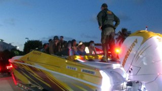 Officials say more than 30 Cuban migrants were found hiding in a go-fast boat during a traffic stop in the Florida Keys.