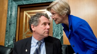 Sen. Sherrod Brown (D-Ohio), left, speaks with Sen. Elizabeth Warren (D-Mass.), during a Senate Banking, Housing and Urban Affairs  in Washington, DC.