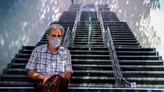 An Iranian man wearing a face mask as protection from Covid-19 sits on a bench at the Grand Bazaar of Iran’s capital Tehran on September 5, 2021.
