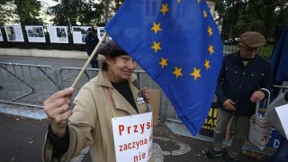 A protester waves an EU flag in front of the Constitutional Tribunal in Warsaw, Poland.