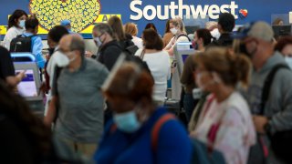 Travelers wait to check in at the Southwest Airlines ticketing counter at Baltimore Washington International Thurgood Marshall Airport on October 11, 2021 in Baltimore, Maryland.