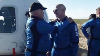 A screenshot taken from a live handout video on October 13, 2021 shows Jeff Bezos talks to William Shatner after Blue Origin’s New Shepard crew capsule landed back in Texas, the United States.