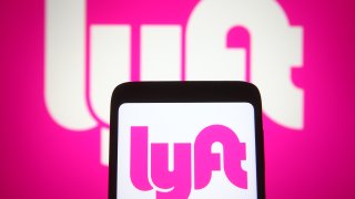 Lyft logo seen on smartphone screen and pc screen
