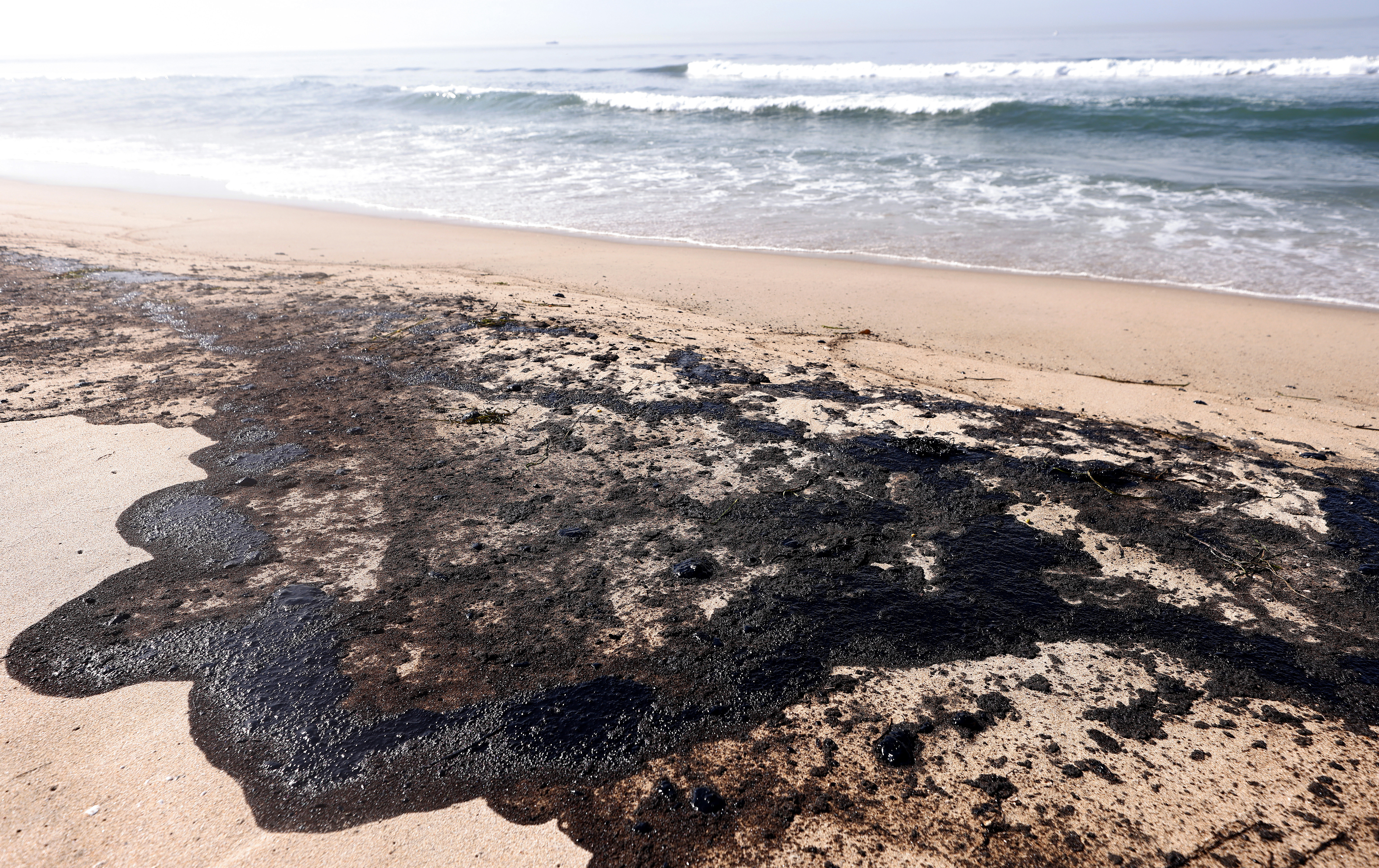 Oil is seen here washed up on Huntington State Beach. The spill forced the closure of the popular Great Pacific Airshow before its final day, with authorities urging people to avoid beaches in the vicinity.