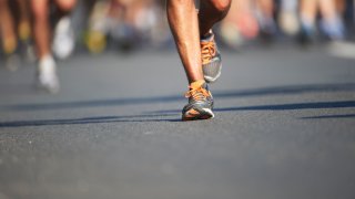 Legs and feet of joggers, running a marathon