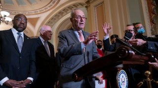 Senate Majority Leader Chuck Schumer, D-N.Y., center, is joined by Sen. Raphael Warnock, D-Ga., left, and Sen. Patrick Leahy, D-Vt.,