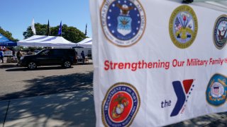 A man receives food at an Armed Services YMCA food distribution, Oct. 28, 2021, in San Diego