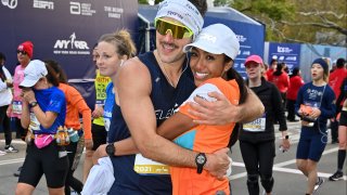 Zac Clark and Tayshia Adams are seen during the 2021 TCS New York City Marathon