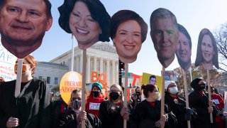 Abortion rights advocates holding cardboard cutouts