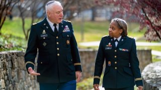 Head National Guard chaplain Col. Larry Bazer, deputy director of the chaplain office, left, and Chaplain Maj. A'Shellarien Lang, right, speak at the National Guard Bureau