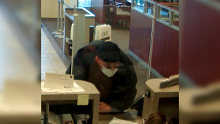 David Marc Ratcliff approaches a teller at a Wells Fargo bank as he robs the bank
