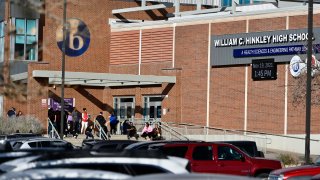 Students and staff gather outside