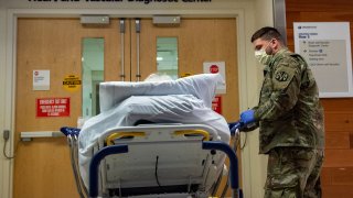 A soldier transports a patient at UMass Memorial Medical Center in Worcester, Massachusetts on December 30, 2021.