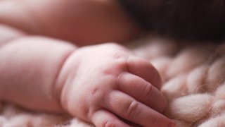 A close up image of a baby’s hand