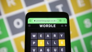 Wordle, a web-based word game is seen on a smartphone screen.