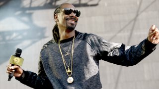Snoop Dogg performing at a concert.