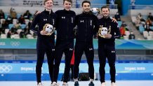 Team USA bronze medallists celebrate during the venue ceremony for the men's speed skating team pursuit