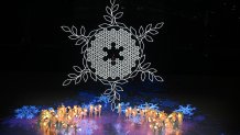 Children carrying snowflake lanterns gather under the snowflake cauldron during the closing ceremony of the Beijing 2022 Winter Olympic Games, at the National Stadium, known as the Bird's Nest, in Beijing, on Feb. 20, 2022.