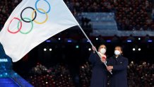 Guiseppe Sala, Mayor of Milano city and Gianpetro Ghedina, Mayor of Cortina d' Ampezzo City wave the Olympic flag during the 2022 Winter Olympics Closing Ceremony, Feb. 20, 2022, in Beijing.