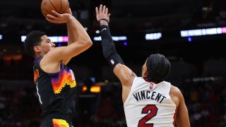 MIAMI, FLORIDA – MARCH 09: Devin Booker #1 of the Phoenix Suns shoots over Gabe Vincent #2 of the Miami Heat during the second half at FTX Arena on March 09, 2022 in Miami, Florida. NOTE TO USER: User expressly acknowledges and agrees that, by downloading and or using this photograph, User is consenting to the terms and conditions of the Getty Images License Agreement. (Photo by Michael Reaves/Getty Images)