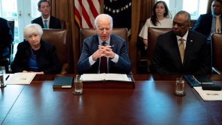 US President Joe Biden, with Treasury Secretary Janet Yellen (L) and Defense Secretary Lloyd Austin (R), speaks during a meeting with his cabinet at the White House in Washington, DC, on March 3, 2022.