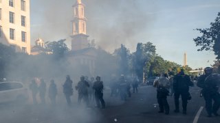 FILE - In this June 1, 2020 file photo police move demonstrators away from St. John's Church across Lafayette Park from the White House, as they gather to protest the death of George Floyd in Washington. Floyd died after being restrained by Minneapolis police officers.