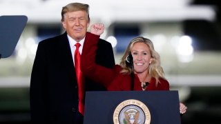 Rep. Marjorie Taylor Greene, R-Ga., speaks as President Donald Trump listens at a campaign rally in support of Senate candidates Sen. Kelly Loeffler, R-Ga., and David Perdue in Dalton, Ga., Monday, Jan. 4, 2021.