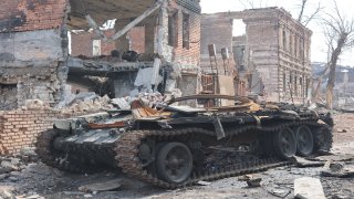 A view of a destroyed armored vehicle during ongoing conflicts